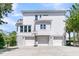 Expansive three-car garage with modern doors and a basketball hoop, offering ample parking at 1720 Bowline Dr, Mount Pleasant, SC 29466