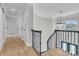 Bright hallway with hardwood floors, chandelier, and curved staircase at 1720 Bowline Dr, Mount Pleasant, SC 29466