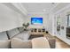 Comfortable living area with plush seating, entertainment center, and access to the outdoor patio via French doors at 1720 Bowline Dr, Mount Pleasant, SC 29466