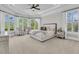 Luxurious main bedroom featuring tray ceilings, plush carpeting, large windows, and elegant furnishings at 1720 Bowline Dr, Mount Pleasant, SC 29466