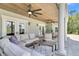 Inviting outdoor patio with covered seating, dining area, ceiling fans, and classic white columns at 1720 Bowline Dr, Mount Pleasant, SC 29466
