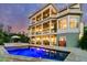 Backyard view highlighting the illuminated pool and multi-level patios of this luxury home at 1720 Bowline Dr, Mount Pleasant, SC 29466