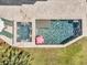Aerial view of the pool and spa with travertine surround and a playful pig float at 1720 Bowline Dr, Mount Pleasant, SC 29466