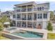 Multi-story home featuring expansive balconies, a sparkling pool, and an inviting outdoor living area at 1720 Bowline Dr, Mount Pleasant, SC 29466