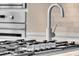 Close up of stainless steel kitchen faucet, stove top, and oven at 1720 Bowline Dr, Mount Pleasant, SC 29466
