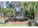 Backyard trampoline surrounded by lush tropical landscaping at 1720 Bowline Dr, Mount Pleasant, SC 29466