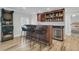 Home wet bar with granite countertop, wine cooler, dartboard, bar stool seating and custom cabinetry at 1720 Bowline Dr, Mount Pleasant, SC 29466