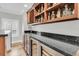 Wet bar with granite countertops, wine fridge, open shelving, and wine rack perfect for entertaining at 1720 Bowline Dr, Mount Pleasant, SC 29466