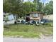 A house has outdoor seating under a tree in a grassy, fenced yard at 1902 Clifton St, North Charleston, SC 29406