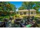 Outdoor patio with stone firepit and Adirondack chairs; the perfect spot for gatherings at 2016 Wild Flower Ln, Charleston, SC 29414