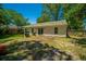 Exterior of the home with sliding glass doors opening to the grassy backyard and barbecue grill at 2016 Wild Flower Ln, Charleston, SC 29414