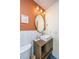 Stylish bathroom offers a modern vanity, elegant round mirror and white herringbone tile to add a modern touch at 2016 Wild Flower Ln, Charleston, SC 29414