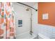 Clean bathroom features white subway tile, bronze fixtures, unique blue niche, and a decorative shower curtain at 2016 Wild Flower Ln, Charleston, SC 29414