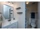 Modern bathroom boasts a new vanity, updated mirror, shelving, and toilet at 2016 Wild Flower Ln, Charleston, SC 29414