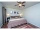 Bright bedroom features a ceiling fan, decor over the bed and hardwood floors at 2016 Wild Flower Ln, Charleston, SC 29414