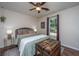 Relaxing bedroom featuring a plush bed, ceiling fan, decorative chest, and a window overlooking the backyard at 2016 Wild Flower Ln, Charleston, SC 29414