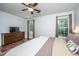 Bright bedroom features a ceiling fan, two windows, decor over the bed and hardwood floors at 2016 Wild Flower Ln, Charleston, SC 29414