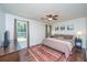 Bright bedroom features a ceiling fan, a window, and a decorative rug under the bed at 2016 Wild Flower Ln, Charleston, SC 29414