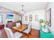 Open-concept dining area flowing into a living room features a wood dining table and a decorative lighting fixture at 2016 Wild Flower Ln, Charleston, SC 29414