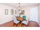 A dining room featuring a wood table, gray upholstered chairs, and a modern light fixture with an accent cabinet at 2016 Wild Flower Ln, Charleston, SC 29414