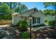 Charming home exterior with a bright turquoise front door, black shutters, and manicured landscaping at 2016 Wild Flower Ln, Charleston, SC 29414