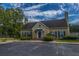 Exterior view of the community clubhouse showing beautiful landscaping and a large parking lot at 2016 Wild Flower Ln, Charleston, SC 29414