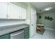 Updated kitchen with stainless steel appliances, granite counters, and white cabinets offers a cozy breakfast nook at 2016 Wild Flower Ln, Charleston, SC 29414