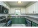 Bright kitchen showcases updated appliances, granite countertops, white cabinets and a window over the sink at 2016 Wild Flower Ln, Charleston, SC 29414