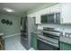 Updated kitchen features stainless steel appliances, granite counters, white upper cabinets, and gray backsplash at 2016 Wild Flower Ln, Charleston, SC 29414