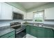 Kitchen featuring stainless steel appliances, granite countertops, white upper cabinets, and unique backsplash at 2016 Wild Flower Ln, Charleston, SC 29414