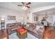 Open-concept living room featuring hardwood floors, comfortable sofas, and a dining area in the background at 2016 Wild Flower Ln, Charleston, SC 29414