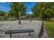 A charming wooden playground sits on a sand base with swings and a bench at 2016 Wild Flower Ln, Charleston, SC 29414