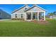 Inviting gray home with a cozy front porch and lush green lawn creating a picturesque curb appeal at 2020 Parish House Cir, Johns Island, SC 29455