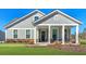 Beautiful home with gray siding, a welcoming front porch, and professionally landscaped front yard at 2020 Parish House Cir, Johns Island, SC 29455