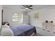 Cozy bedroom with a large window, ceiling fan and neutral colors at 2045 Vestry Dr, Charleston, SC 29414