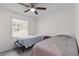 A cozy bedroom featuring two twin beds, a ceiling fan, and a window offering natural light at 2045 Vestry Dr, Charleston, SC 29414