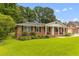 Charming brick home with manicured lawn, covered porch, and attached garage at 2045 Vestry Dr, Charleston, SC 29414