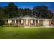 Charming single story brick home featuring a manicured front lawn and covered porch with swing at 2045 Vestry Dr, Charleston, SC 29414