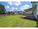 Expansive green backyard with a wooden privacy fence and covered deck at 214 Center Hill Ct, Summerville, SC 29485