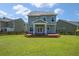 A well-manicured backyard features a wooden deck, lush green grass, and a privacy fence at 214 Center Hill Ct, Summerville, SC 29485
