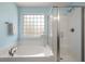 Bathroom with a soaking tub, glass enclosed shower, and a window for natural light at 214 Center Hill Ct, Summerville, SC 29485