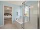 Light and airy bathroom featuring a soaking tub and glass enclosed shower with bedroom access at 214 Center Hill Ct, Summerville, SC 29485