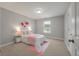 Comfortable bedroom with a window providing natural light and soft pink accents at 214 Center Hill Ct, Summerville, SC 29485