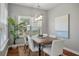 Dining area with a wooden table, six chairs, a jute rug, and a large window with natural light at 214 Center Hill Ct, Summerville, SC 29485