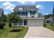 Charming two-story home with green siding, shuttered windows, a 2-car garage and manicured lawn at 214 Center Hill Ct, Summerville, SC 29485