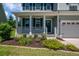 Inviting front porch with flower bed and blue front door with decorative wreath at 214 Center Hill Ct, Summerville, SC 29485