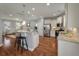 Bright kitchen features stainless appliances, an island with stool seating, and opens to the living room at 214 Center Hill Ct, Summerville, SC 29485