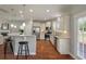 Bright kitchen features stainless appliances, an island with stool seating, and opens to the living room at 214 Center Hill Ct, Summerville, SC 29485