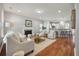 Bright living room featuring a cozy fireplace, wood floors, and an open layout to the kitchen at 214 Center Hill Ct, Summerville, SC 29485