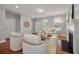 Cozy living room with wood floors, fireplace, and open doorway to the kitchen at 214 Center Hill Ct, Summerville, SC 29485